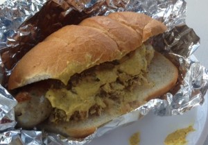 Bratwurst on a roll with sauerkraut and mustard